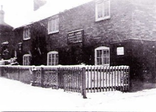 Winter scene showing the sign over the front door