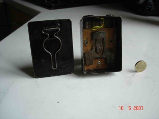 Torch_2 WW1 German Torch - Note the metal loop on the sliding back plate, this, provided in order to secure the torch to coat button. The continental style three cell 4.5 volt battery is still available.
