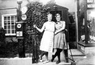Nancy Goodson (Mrs. Moulsher) and Jane Randell (Mrs. Spick) outside Randell's shop later Moulsher's Grocery