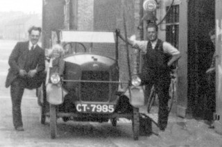 Angela Marsh_High St. right crop car close-up Picture showing garage staff and customer with an open topped car, 1920s at Christmas and Chorlton's Garage, High St., Bottesford