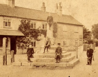 BOT025_031_MS Old Cross 1 v2 Late Victorian children sitting on the steps of the Market Cross, Bottesford: a faded sepia print enhanced digitally | Contributed by Mr Mike Saunders
