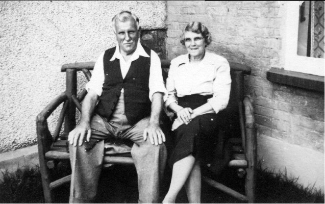 Grandad and Grandma Spick, elderly couple seated on a bench outisde their house | Neville Spick