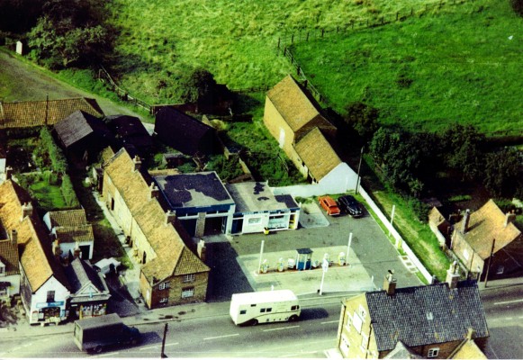 High St, an aerial photograph: shops, cottages and petrol station at the eastern end of the street c.1960, most of the old buildings were demolished soon afterwards | Mr David Plummer