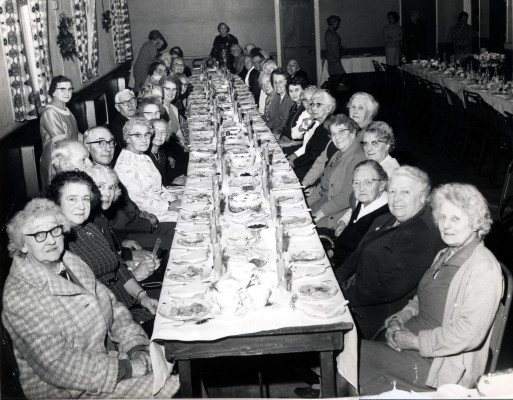 Roberts Builders staff dinner, probably in the village hall - workers and spouses seated along long tables probably in the village hall | Mr Ian Norris