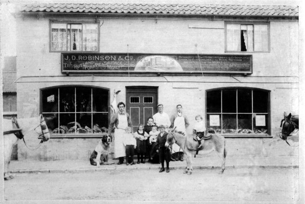 J.D. Robinson's shop - Mr Robinson and his family in front of their butchers shop on the Market Place in Bottesford. | From the collection of David Hampson