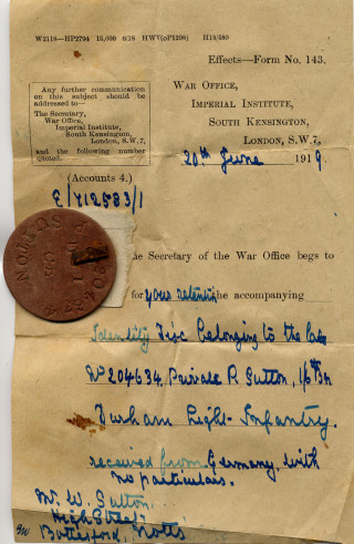Philip Sutton tag #1 Philip Sutton's soldier's identity tag, and the letter which was sent by an anonymous German soldier in June, 1919 to his family. | From a private collection.