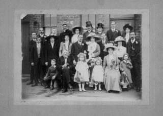 Tommy Robinson (back row, 3rd from right) wearing a top hat at the wedding of his sister Mary. | From the collection of the late Mr Geoff Parr