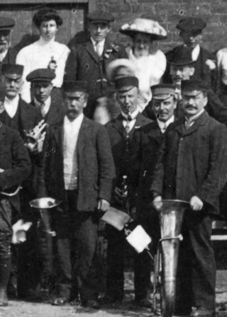 bot002_006-albert-allen-at-centre Bottesford village band at the Coronation Celebration of George V in 1911: Albert Allen, proprietor of the Tea Rooms and possibly John Allen's father, is the man smoking a pipe at the centre of the image. | Bottesford Heritage Archive BOT/002/006, contributed by the late Mrs Dorothy Beedham.