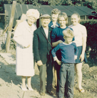 Dawson_Norman_IanMcCraight_0001 002 In the gardens at South Normanton: from the left - Doris Dawson, Norman Dawson (wearing cap), Audrey McCraight (nee Dawson) and Audrey's three children Hilary, Linda and, standing at the front, Ian. | By courtesy of Mr Ian McCraight.