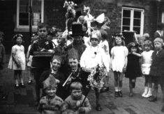 Children prepare for May Day celebrations, 1953 Coronation Year.