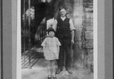 Tommy Robinson and child at the church porch.