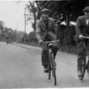 Three men cycling to or from work, Belvoir Road
