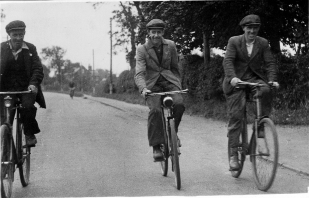 Three men cycling to or from work, Belvoir Road
