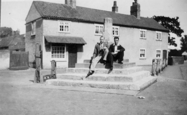 Seated on the steps of the market cross in Bottesford market place. | Mrs Anne Hewitt, Bottesford Local History Archive
