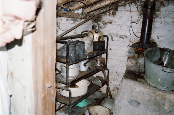 This is the interior of the small lean-to added beyond the kitchen. In the right-hand corner is the old water heater used for laundry.