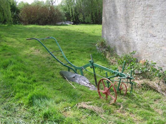 The plough, standing on the grass outside the Lock House cottage. | Neil Fortey
