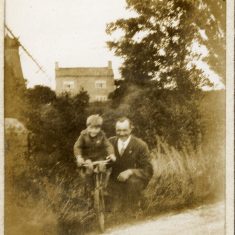 BOT177_011 Marston album1 11 #2 In this picture, a man and boy pose by the side of Belvoir Road just north of the mill by the Grantham Canal. In the background are the mill wheel and house. The boy may be the younger son, Frank Marston. | Janet Dammes