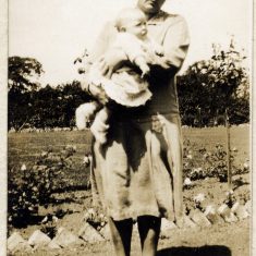 BOT177_012 Marston album1 12 #2 Eve Marston and baby, probably her youngest, Daphne, on a path by a vegatable bed, though the exact location is uncertain. | Janet Dammes