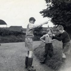 'Geoffrey playing conkers with Tony and Angela Marsh on the corner of Station Road and Rectory Lane, Bottesford, September 1960.' | Janet Dammes