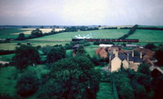 Bottesford for Belvoir - slide 44b Taken by Police Sgt Artur Bradshaw during a visit to the top of Bottesford St Mary's tower c.1950. A passenger train heads west beyond Beckingthorpe Farm. Slides 44a and 44b show parts of the same photo negative. | Donated by Mr Michael Bradshaw