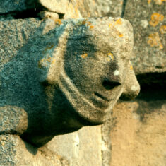 The second of two heads on the ends of the cappings of the buttresses supporting the north transept. | Neil Fortey