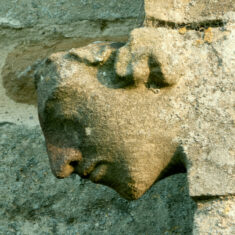 One of two heads on the ends of the cappings of the buttresses supporting the north transept. | Neil Fortey
