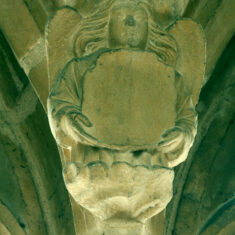 Carvings on the southern side of the clerestory are of angels that seem to be almost floating above the nave. They carry a scroll-like banner or a shield, which would once have been painted, the scroll perhaps with music, the shield with a coat of arms.