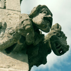 The second view of the carving depicting a double figure, a man, apparently holding a sword in his right hand and a small, circular shield or drum in his left, accompanied by a winged dragon-like creature bearing its fearsome teeth. | Neil Fortey