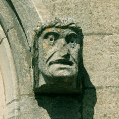 A man's head gazing from the southern aisle of St Mary's; 'Angels and Dragons' front cover picture.  | Neil Fortey