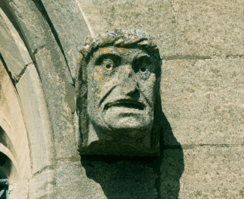 A man's head gazing from the southern aisle of St Mary's; 'Angels and Dragons' front cover picture.  | Neil Fortey