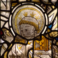 P1070448_04 Medieval stained glass displayed in the SW window of the chancel clerestory. These are all that remains of what was once a large series located in the clerestory of the nave of St Mary’s and described by Nichols (1795). The bishop is said to be Leofric, Bishop of Exeter (1050—1072). | Neil Fortey