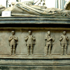 Six weepers on the southern side of the tomb of the 1st Earl of Rutland. These panels of weepers are intended to represent the children of the Earl and Countess. | Neil Fortey