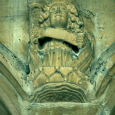 The roof of the nave is supported by stone corbels carved as angels, some holding scrolls, others holding shields. As with many of the other carvings mounted close beneath the roof, these have their eyes picked out in black paint, in these cases applied to the pupils rather than the whole eyes as in the case of the demonic carvings. | Neil Fortey