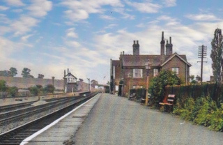 Picture 12 A beautiful picture looking eastwards, probably 1950s. Note the gas lights on the downline platform and the signal box standing on the upline platform. | From an old hand-coloured postcard, Bottesford Local History Archive