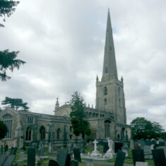A panoramic view of St Mary’s church and graveyard, seen from the northeast. The height of the clerestory and the intrusive presence of the north transept make it difficult to view or photograph the carvings located high up on its structure. | Neil Fortey