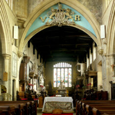 Looking eastwards through the chancel arch into the chancel itself, with its tombs and the east window. The 'doom' painting was made on the wall above the arch, which cut into the painting when it was raised during the 19th Century. In addition, the painting was concealed beneath plaster and remained unseen until its damaged remains were discovered in 1967. | Neil Fortey
